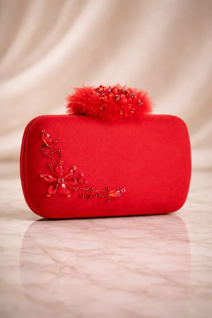 modelo con clutch rojo de fiesta con pedrería y pendientes largos elegantes